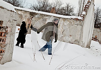 Homeless couple walking in the snow holding hands Stock Photo