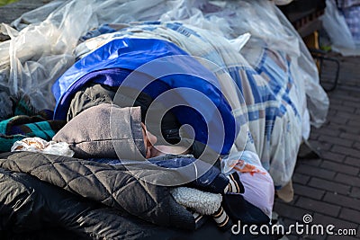 Dirty lonely woman sleeping on a bench Editorial Stock Photo