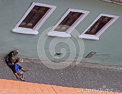 Homeless, dirty woman and her son are liying on street asphalt in Sibiu, Romania Editorial Stock Photo