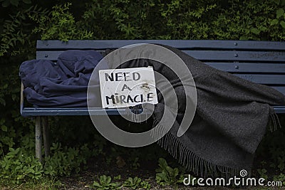 Homeless man on park bench Stock Photo