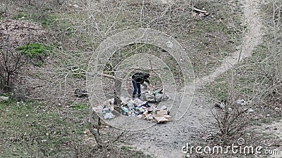 Homeless Man Rummages the Garbage and Sorting Plastic Bottles Stock ...