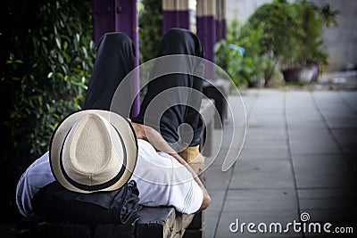 Homeless man sleeps on the street chair Stock Photo