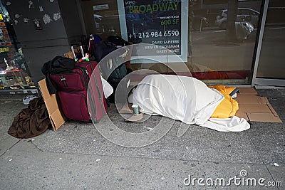 Homeless man straggling during cold weather in Midtown Manhattan Editorial Stock Photo