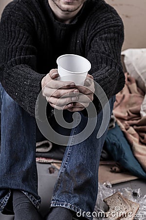 Homeless man waiting for alms Stock Photo