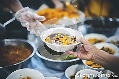 Homeless and needy people receive help, receive food from volunteers : concept of food donation Stock Photo