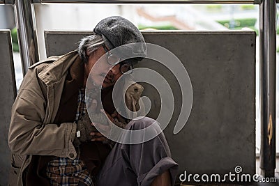 Homeless old man heart attack in city Stock Photo