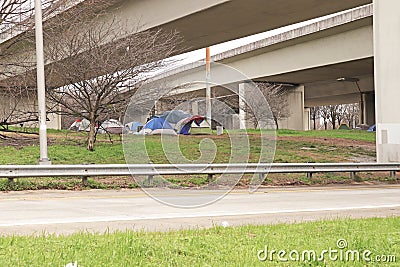 Homeless people camped out under a bridge multiple tents Editorial Stock Photo