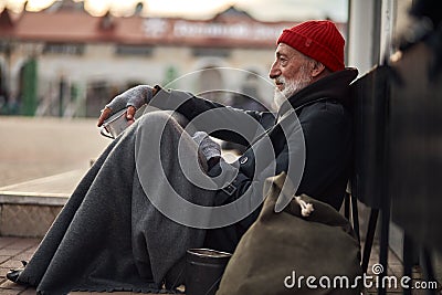 Homeless person waiting help. Unemployed beggars live on street Stock Photo