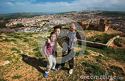 Homeless poor children in ancient Fes city ruins mountain, Fes, Morocco Editorial Stock Photo