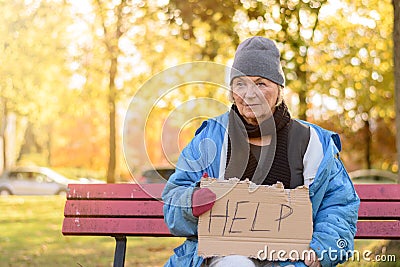 Homeless or poverty stricken elderly lady Stock Photo