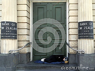 Homeless sleep under the doorway of New Zealand Bank Editorial Stock Photo