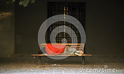 Homeless sleeping in a bench Stock Photo