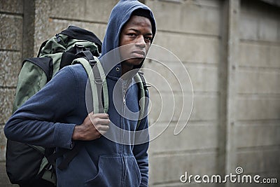 Homeless Teenage Boy On Streets With Rucksack Stock Photo