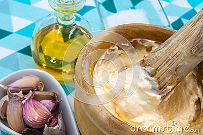 Homemade alli i oli sauce in a wooden mortar typical from Catalonia Stock Photo