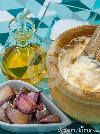 Homemade alli i oli sauce in a wooden mortar typical from Catalonia Stock Photo