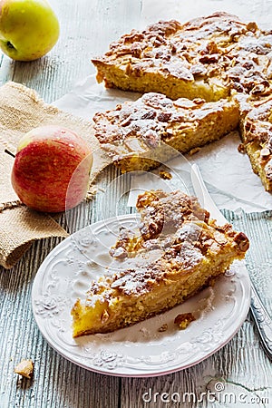 Homemade apple and almond cake. Piece of pie on white plate and fresh fruits Stock Photo