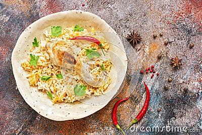 Homemade Arabian biryani overhead view on a rustic background with spices. Chicken Kabsa Stock Photo