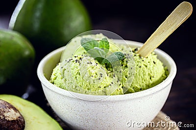Homemade avocado ice cream, made with frozen organic fruits with no added sugar or dairy. Vegan dessert. Dessert served in Stock Photo