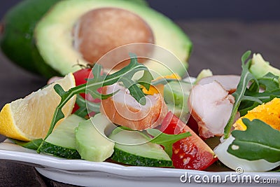 Homemade avocado salad with rucola, chicken chops and mixed vegetables Stock Photo