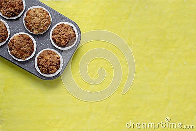 Homemade baking concept - fresh baked muffins on cooling rack, minimal picture, bright yellow background, background, top view, Stock Photo