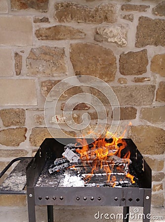Homemade barbecue with firewood under beautiful orange flames Stock Photo