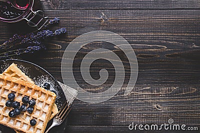 Homemade belgian waffles with blueberries on the dark wooden tab Stock Photo