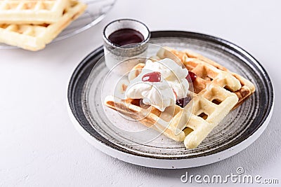 Homemade Belgian Waffles served with whipped cream Chantilly and berry jam Stock Photo