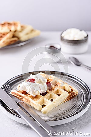 Homemade Belgian Waffles served with whipped cream Chantilly and berry jam Stock Photo