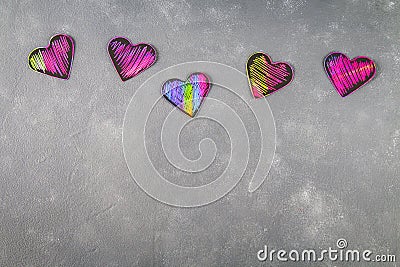 Homemade Black violet pink hearts on a gray concrete background. The concept of Valentine's Day. A symbol of love. Stock Photo