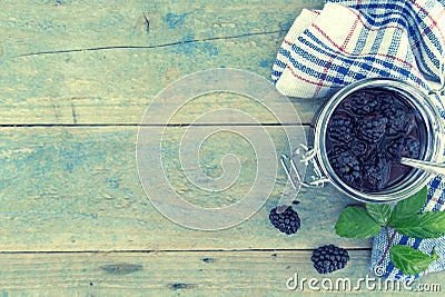 Homemade blackberries jam in a glass jar over rustic wooden table. Healthy food concept. Organic berries. Top view Stock Photo