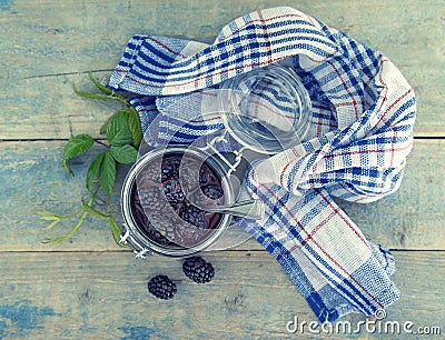 Homemade blackberries jam in a glass jar over rustic wooden table. Healthy food concept. Organic berries. Top view Stock Photo