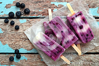 Homemade blueberry vanilla ice pops in a cluster on paper Stock Photo