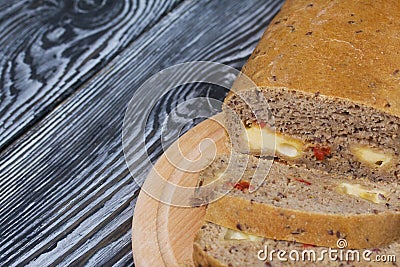 Homemade bread with tomatoes and cheese. Several slices are cut. They lie next to the loaf Stock Photo