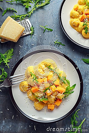 Homemade Butternut squash gnocchi with wild rocket and parmesan cheese Stock Photo