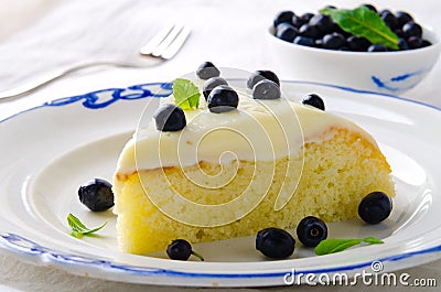 Homemade cake with cream, blueberries and mint on white background Stock Photo