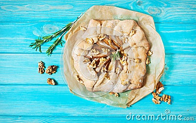 Homemade cake with pears and walnuts on blue wood background Stock Photo