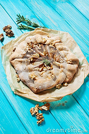 Homemade cake with pears and walnuts on blue wood background Stock Photo