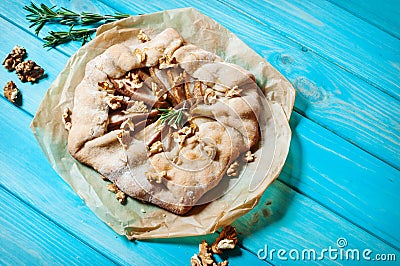 Homemade cake with pears and walnuts on blue wood background Stock Photo