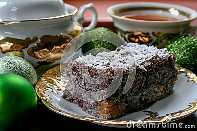 Homemade cake with poppy seeds served on a plate with a cup of coffee Stock Photo