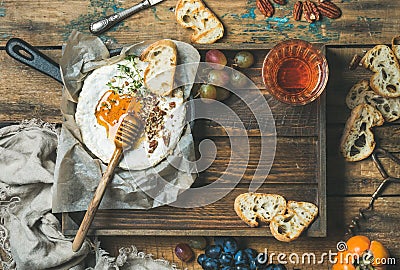 Homemade camembert with honey, glass of rose wine and baguette Stock Photo