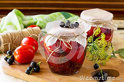 Homemade canning. Pickles tomatoes with black currant Stock Photo