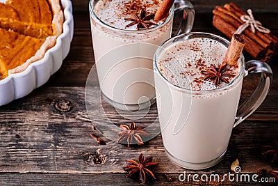 Homemade Chai Tea Latte with anise and cinnamon stick in glass mugs with pumpkin pie Stock Photo