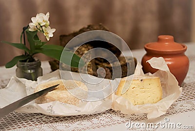 A homemade cheese, bread and an orchid Editorial Stock Photo