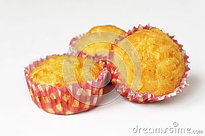 Homemade cheese muffins in a paper form on a white background. Isolate. Close-up. Stock Photo