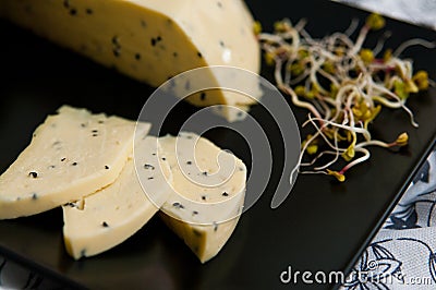 Homemade cheese with Nigella sativa seeds and radish sprouts Stock Photo