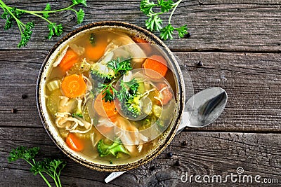 Homemade chicken vegetable soup, top view on rustic wood Stock Photo