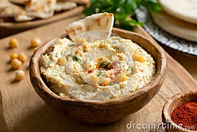 Homemade chickpea hummus bowl with pita chips and paprika Stock Photo