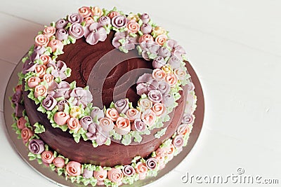 Homemade chocolate cake with colorful cream flowers Stock Photo