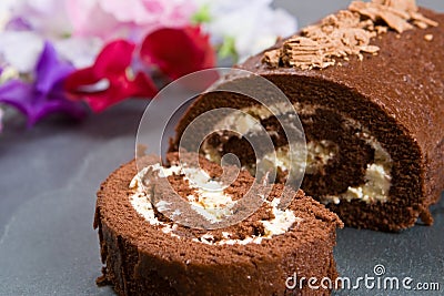 Homemade chocolate roll with fresh flowers Stock Photo