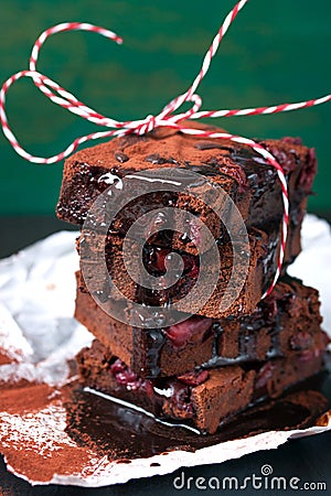 Homemade chocolate sweet brownies cakes with cherry and chocolate sauce or syrup on a dark background, horizontal Stock Photo